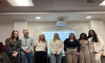 An image of students at their Showcase Event smiling